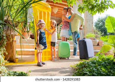 Family Arriving At Holiday Villa With Luggage And Toys, Smiling On Summer Vacation Outdoors, Enjoying Trip Together Abroad, Beach Lilos And Inflatables, Travel Leisure Recreation Fun Lifestyle. 