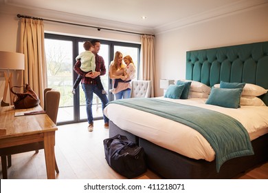 Family Arriving In Hotel Room On Vacation