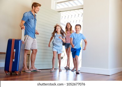 Family Arriving At Summer Vacation Rental