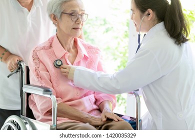 Family Asian Doctor Or Smiling Nurse Checking,listening Senior Patient’s Chest Through Stethoscope,young Female Caregiver Examining Elderly Woman In Wheelchair,healthcare,medical Checkup Concept
