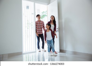 Family Asian Entering Their New Home. Buying New House Concept