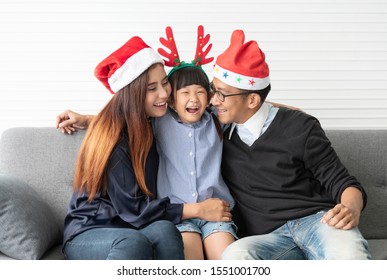 Family Asian Mother And Father With Daughter Celebration Happy Christmas Together In Livingroom At Home.