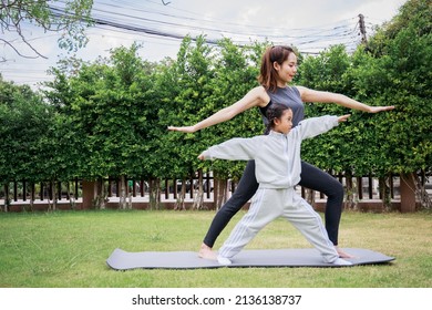 Family Asian Mother teacher training yoga child daughter on a yoga mat at home garden. Family outdoors. Parent with child spends time together. exercise at home concept and new normal.

 - Powered by Shutterstock