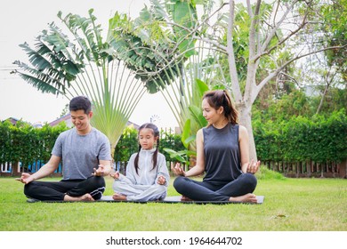 Family Asian parent and child daughter preparing to play yoga together on a yoga mat at home garden. Family outdoors. Parent with child spends time together. exercise at home concept and new normal.

 - Powered by Shutterstock