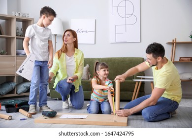 Family Assembling Furniture At Home