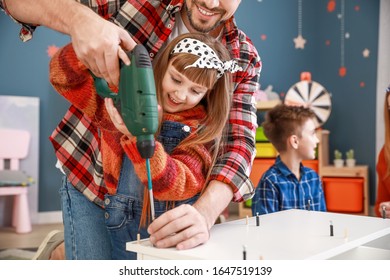 Family Assembling Furniture At Home