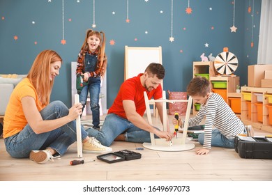 Family Assembling Furniture At Home