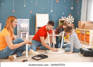 Family Assembling Furniture At Home