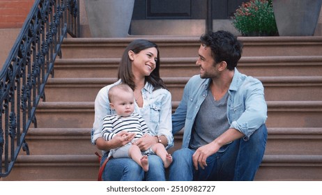 Family With Baby Daughter Sitting Steps Outside Home On Urban Street In New York City USA - Powered by Shutterstock