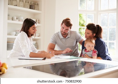 Family With Baby Meeting Financial Advisor At Home