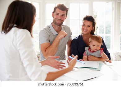 Family With Baby Meeting Financial Advisor At Home