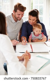 Family With Baby Meeting Financial Advisor At Home