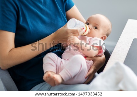 Similar – Image, Stock Photo Mother bottle feeding baby at home