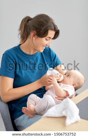 Similar – Mother feeding baby with baby bottle