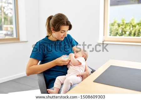 Similar – Image, Stock Photo Mother bottle feeding baby at home