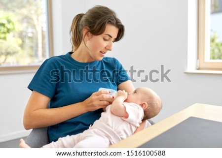 Similar – Image, Stock Photo Mother bottle feeding baby at home