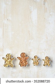 Family Baking Forms With Cereals Over Wooden Table, Above View