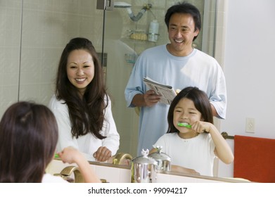 Family In Bathroom Getting Ready For Day