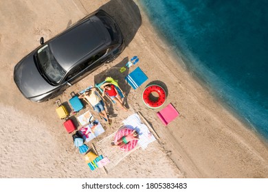 Family With Beach Accessories And Car Near River, Aerial View. Summer Trip