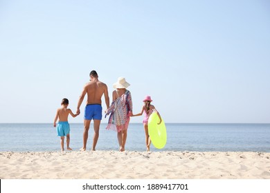 Family At Beach On Sunny Summer Day