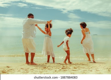 Family Beach Trip Concept : The Race Ran Under The Family's Arms : Enjoy A Fun Run For Family, Parents And Daughters Of Mixed African-American And Thai Descent On The Clean Beach On A Sunny Summer