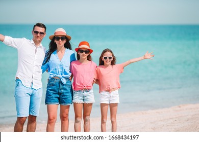 Family beach vacation. Portrait of parents and kids - Shutterstock ID 1668434197