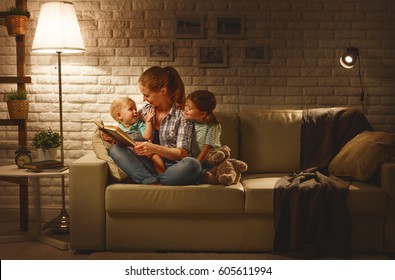 Family before going to bed mother reads children a book about a lamp in the evening
 - Powered by Shutterstock