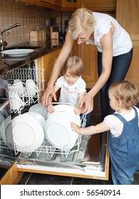 Family Besides Open Dishwasher In The Kitchen