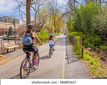 Family bike ride on urban shared path in the city
