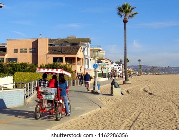 A Family Bikes Along A Los Angeles Beach In A Group Bicycle Cart - Los Angeles, California (USA)