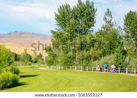 Family biking along the greenbelt in Boise, Idaho