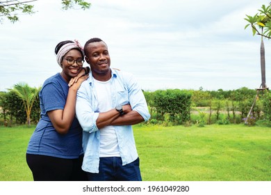 Family of black Africa Americans. They are playing activities and bright smile. Concepts of relationship building and leisure activities in the garden. Being the best couple love - Shutterstock ID 1961049280