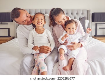 Family, bonding and bed time with children and parents smile and rest together, loving and caring in bedroom. Play, sleep and routine by young man and woman enjoy the morning with happy girl in home - Powered by Shutterstock