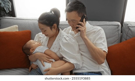 Family bonding in living room with mother cradling baby while father talks on phone, showcasing domestic scene with love and togetherness. - Powered by Shutterstock