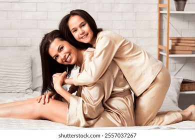 Family bonding. Smiling mom and her teenage daughter embracing in bedroom, panorama - Powered by Shutterstock