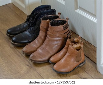 Family Boots Lined Up In Hallway Side View