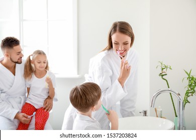 Family Brushing Teeth In Bathroom