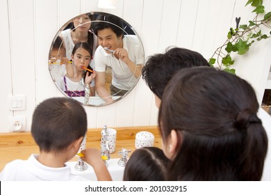 Family Brushing Their Teeth