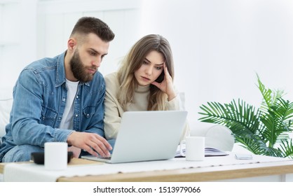 Family Budget. Young Couple Using Laptop For Managing Expanses And Making Notes, Free Space