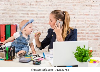 Family Business - Telecommute Businesswoman And Mother With Kid Is Making A Phone Call