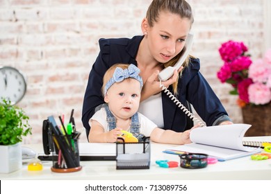 Family Business - Telecommute Businesswoman And Mother With Kid Is Making A Phone Call