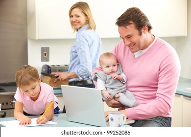Family Busy Together In Kitchen
