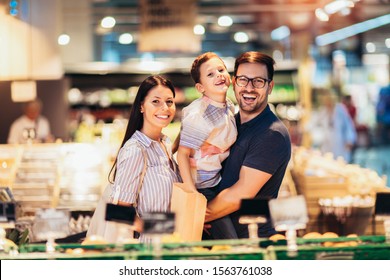 Family Buying Fruit In Supermarket