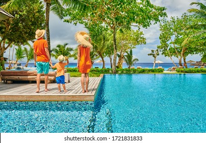 Family By Poolside, Young Couple With Three Year Old Toddler Boy. Resort Swimming Pool At Mahe, Seychelles.