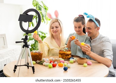 Family Call On The Phone In The Kitchen Decorated For Easter. Easter