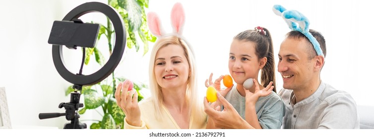 Family Call On The Phone In The Kitchen Decorated For Easter. Easter