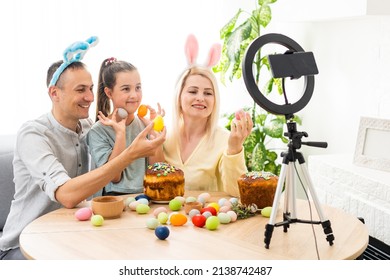 Family Call On The Phone In The Kitchen Decorated For Easter. Easter