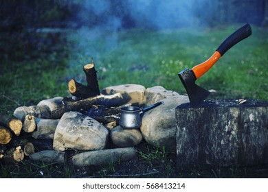 Family Camping And Cooking Sausages In Campfire.