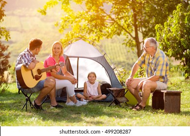 Family Camping In The Countryside With Tent
