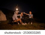 Family camping night party with BBQ, and wine by the atmosphere is relaxed, capturing a moment of leisure enjoying a relaxed while sitting on folding chairs around a portable holiday camping.